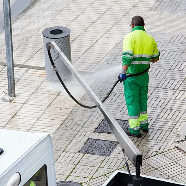 worker-cleaning-a-street-sidewalk-with-water-2025-02-02-13-46-50-utc-68a2dcdd20192