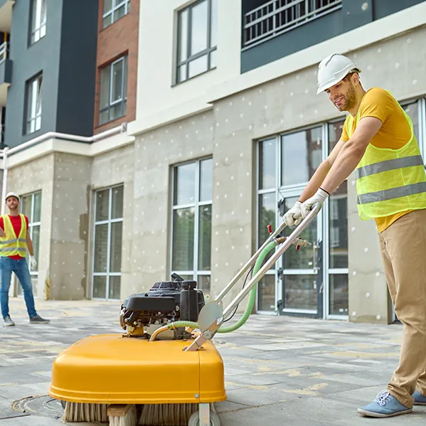 worker-cleaning-construction-site-and-two-men-near-2024-10-18-04-47-12-utc-68a2dcdb422e1